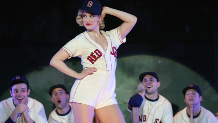 Lola posing in a baseball uniform